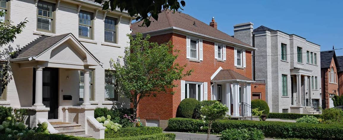 Row of 1920s style brick two story suburban homes.