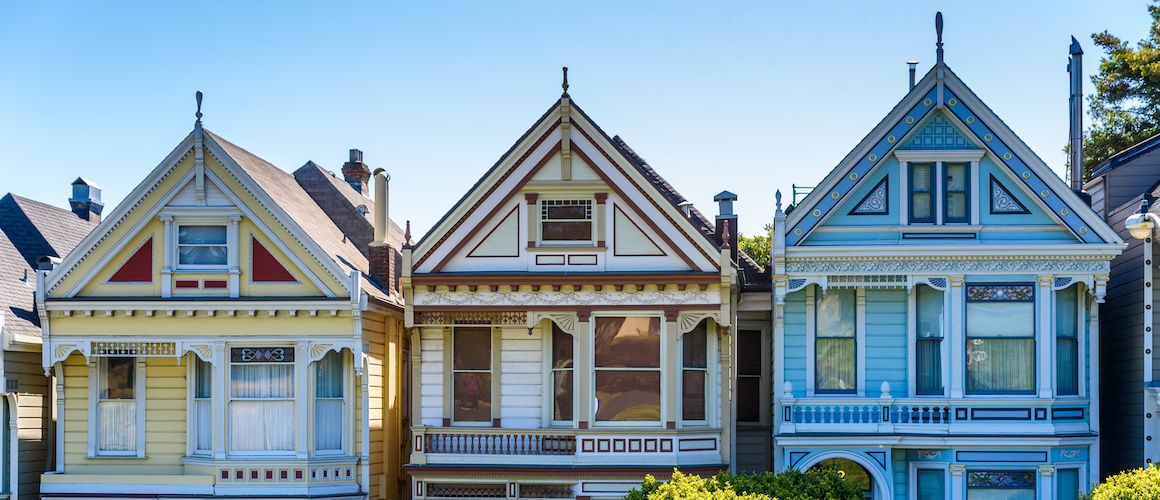 Row of brightly painted homes next to each other.
