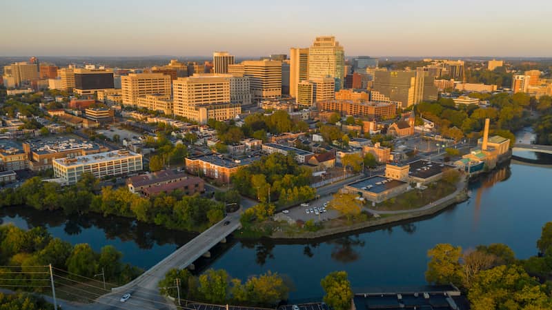 Downtown Wilmington skyline along the Delaware River at dusk.