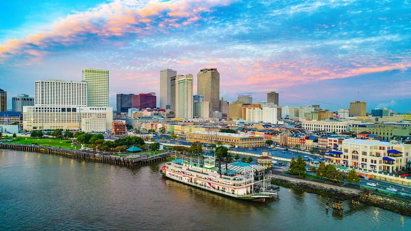 New Orleans skyline along the river with docked steam boat.