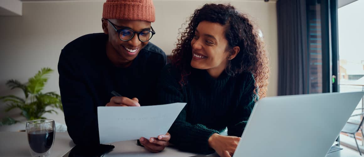 Couple looking at home buying information together.
