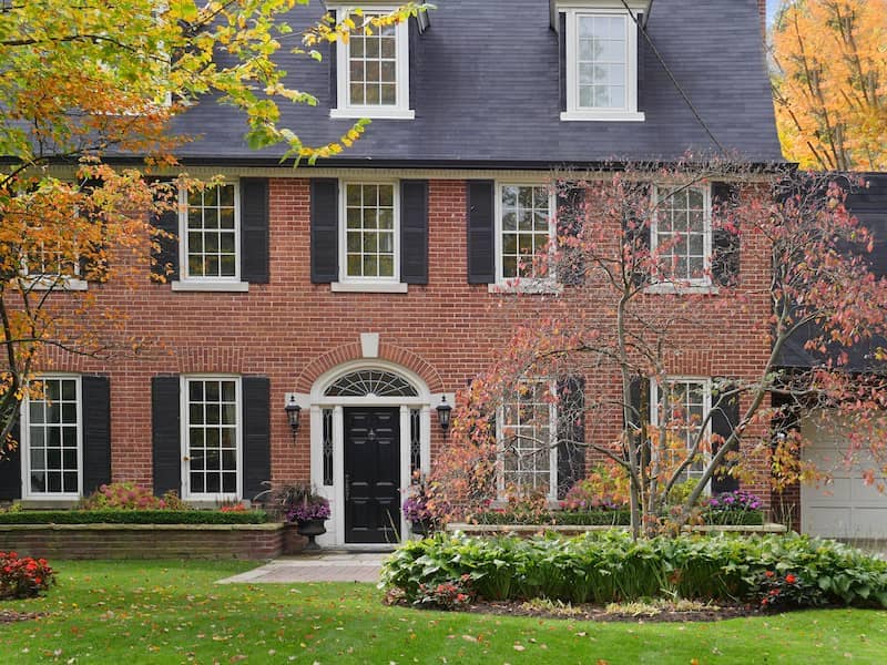 The red brick exterior of a Federal-style home.