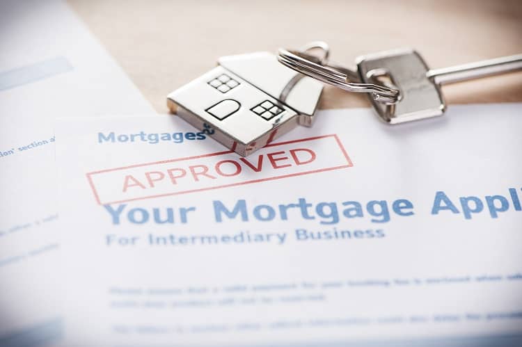 Mortgage agreement paperwork and house keys