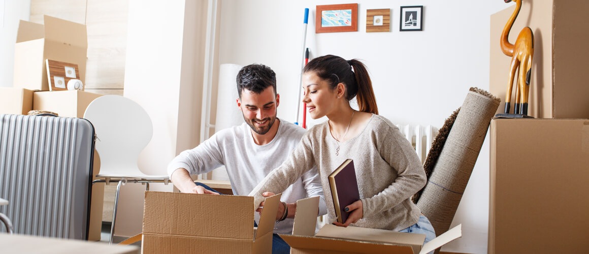 Couple unpacking moving boxes.