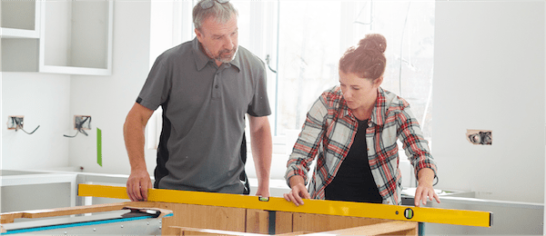Father and daughter remodeling kitchen.
