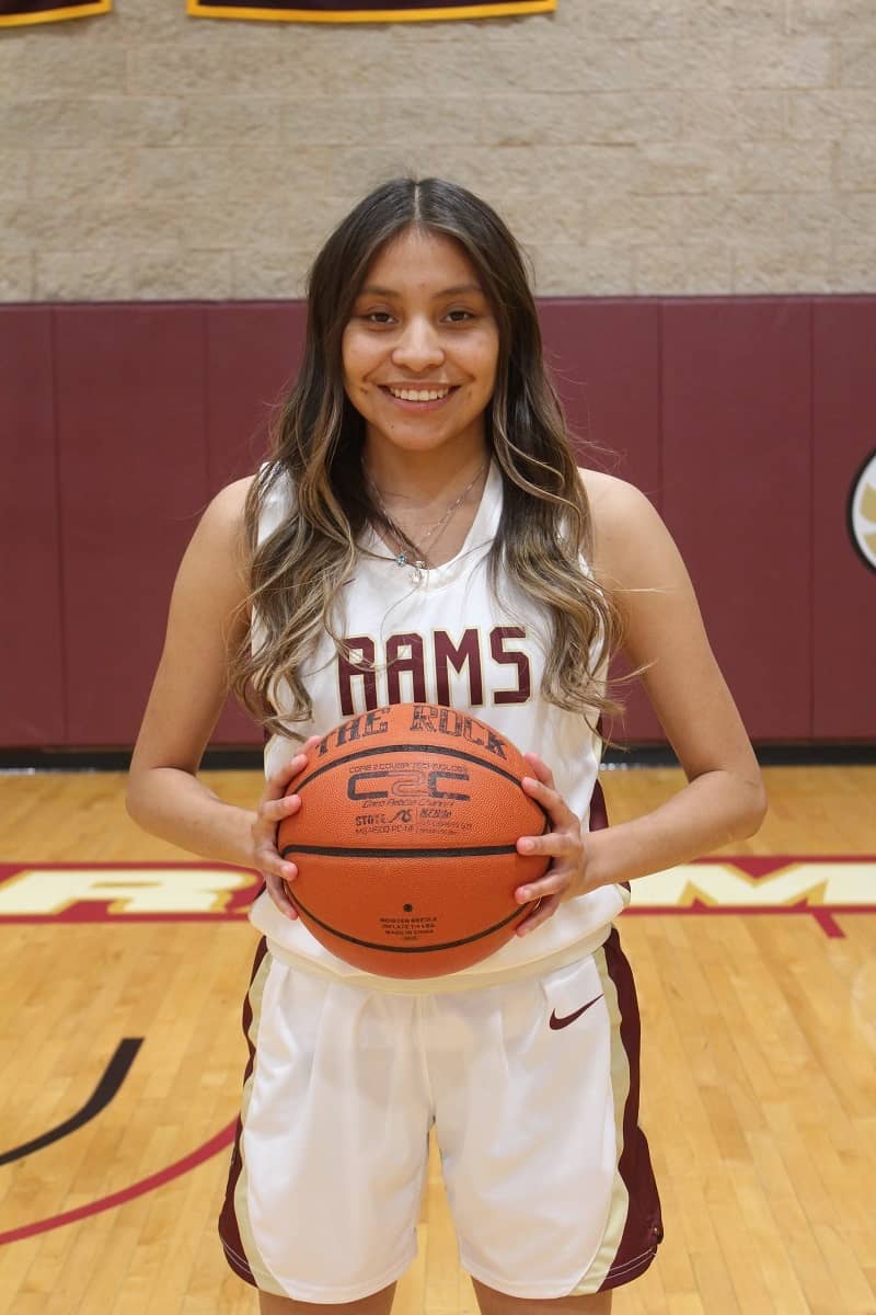 Quiana grinning with basketball.