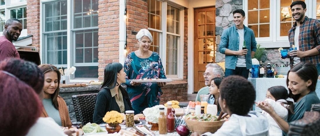 family gathered around table eating and drinking