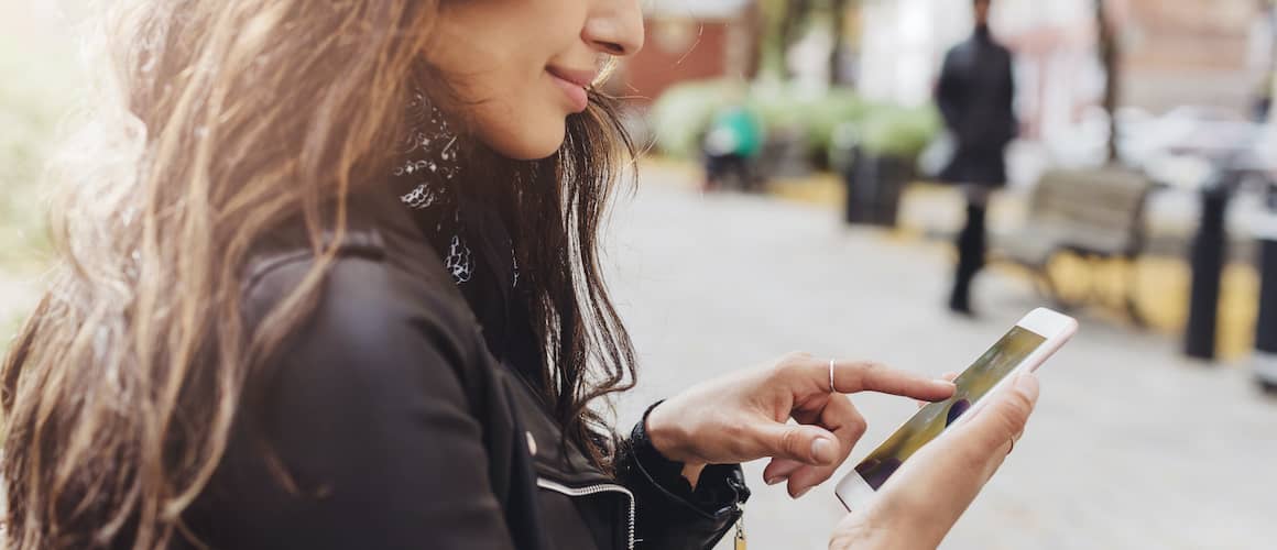 Woman on cell phone searching for absentee owner of a home.