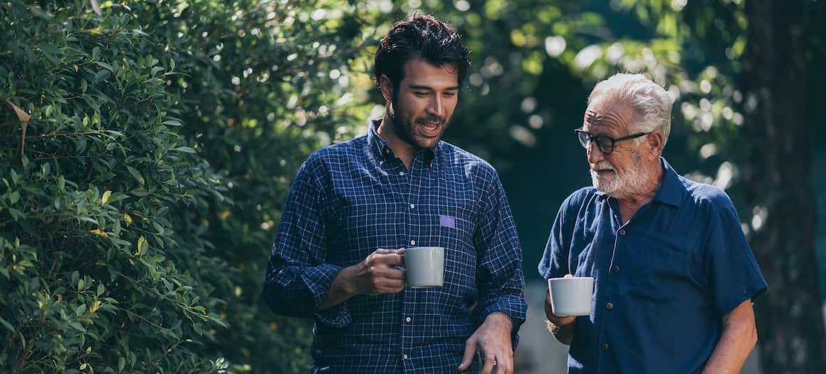 adult son talking to senior father