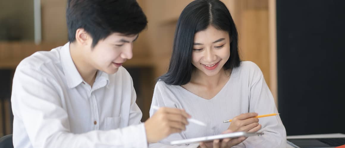 Asian Couple Looking At Tablet
