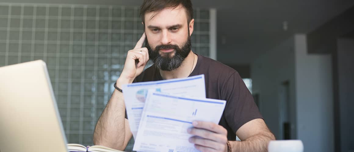 Bearded man looking at documents