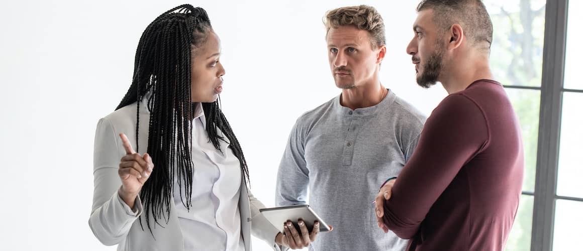 Black Woman Real Estate Agent Talking With Gay Couple