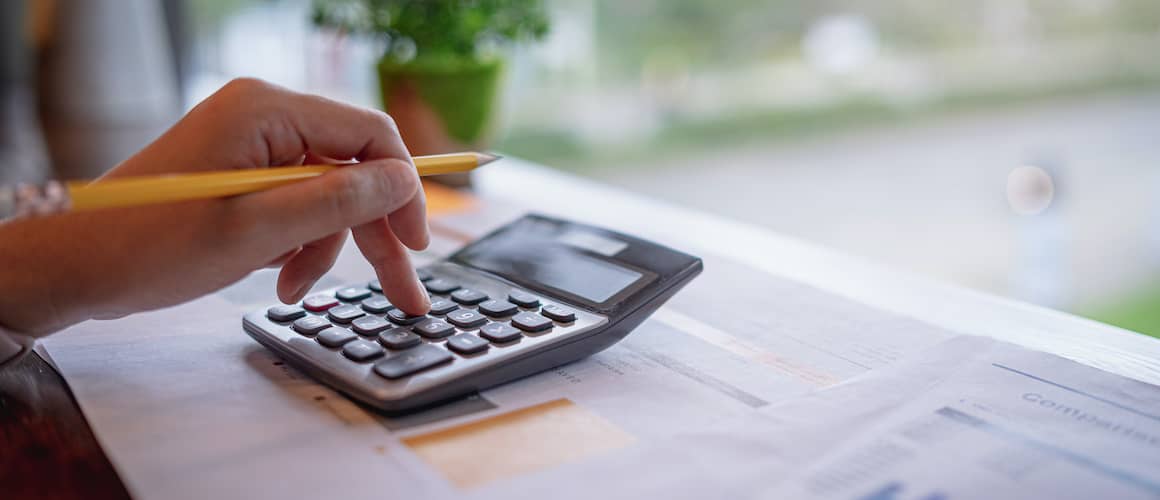 calculating formulas with pencil in hand