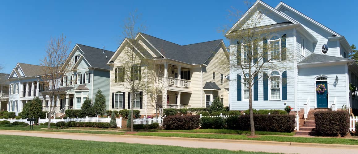 Row of homes for sale in spring.