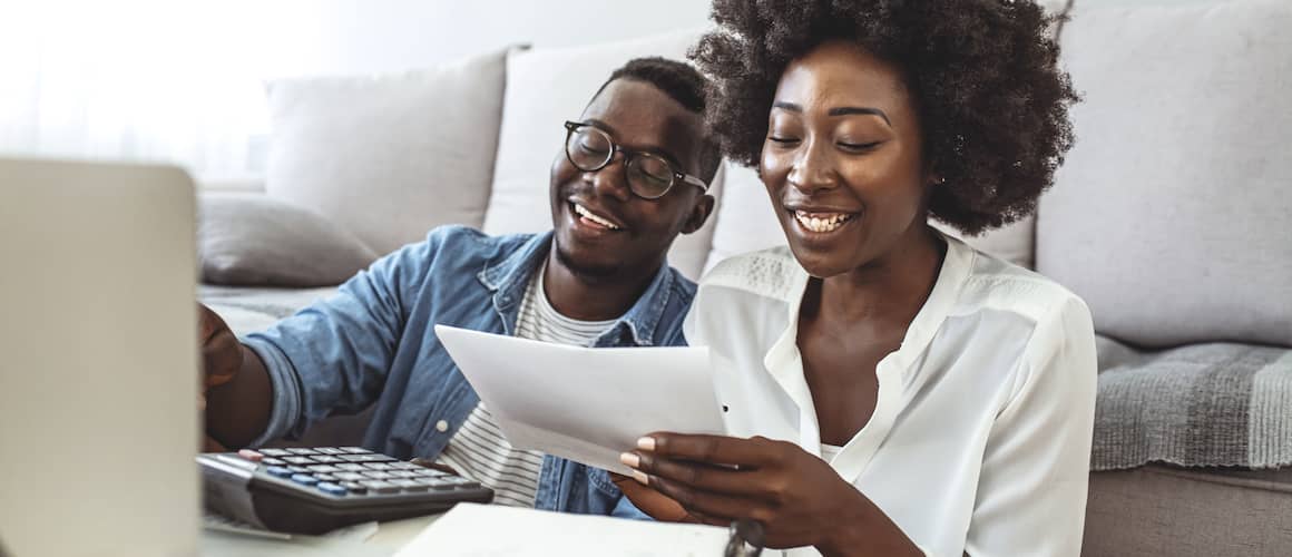 couple doing taxes on laptop