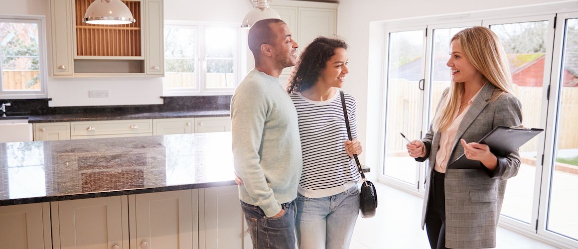 Couple looking at a home with a realtor.