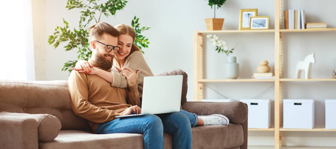 couple on couch on laptop