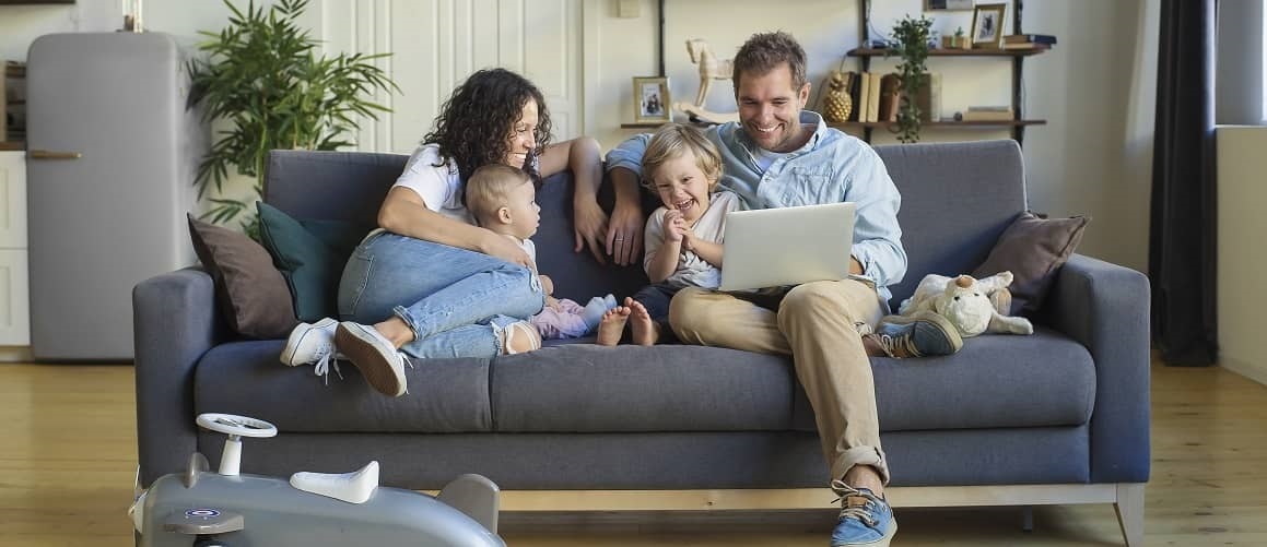 Happy couple relaxing in house with children.