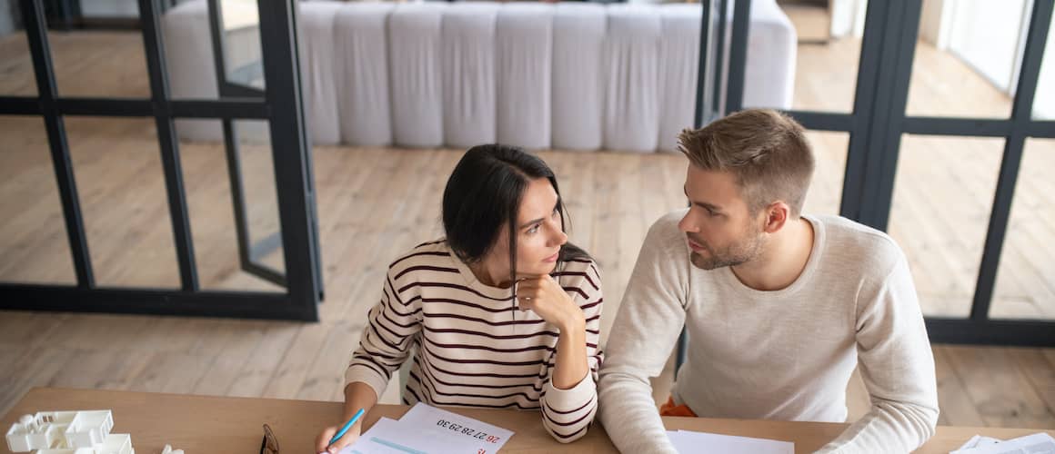 Couple discussing finances for a prospective new house.