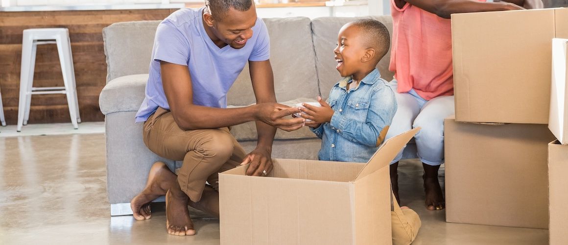 Family unpacking their assets in their new home.