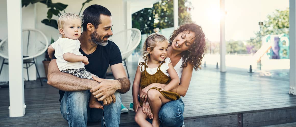 Young family on outdoor porch.