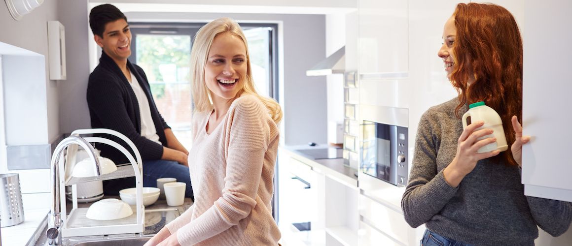 Group of friends in the kitchen, living together.