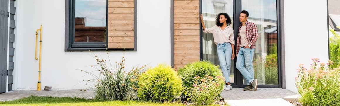 Couple In Front Of Home Awaiting Hybrid Appraisal