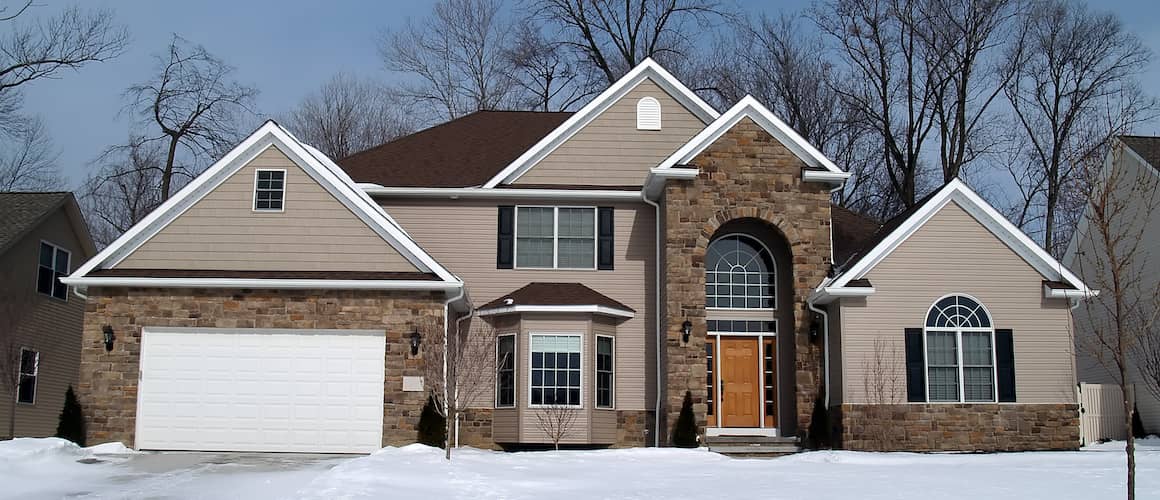 Light Brown Sided Two Story Home With Brick Accents