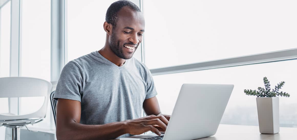 Man on laptop at home.