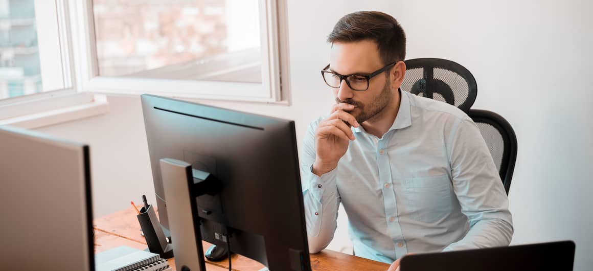 man on multiple computers