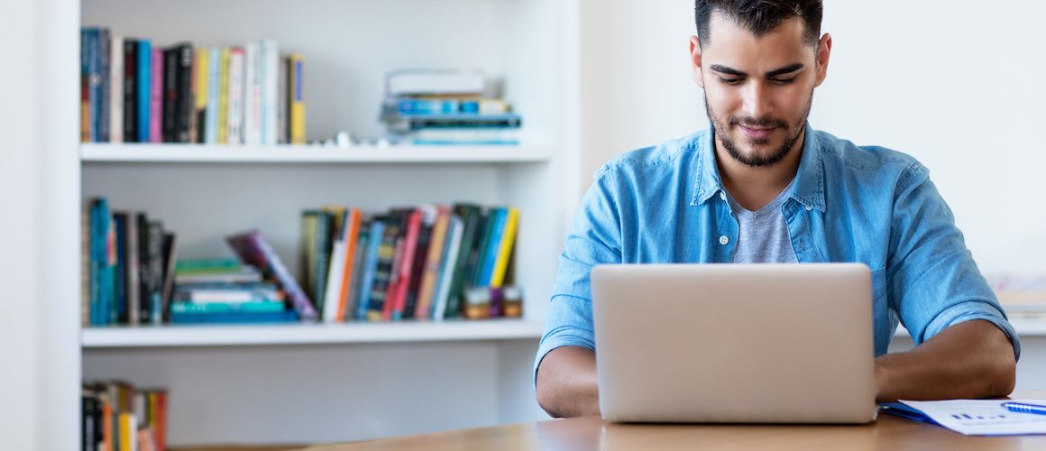 Man on computer researching.