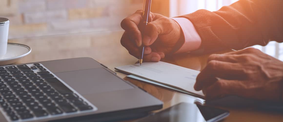 Man writing a check.