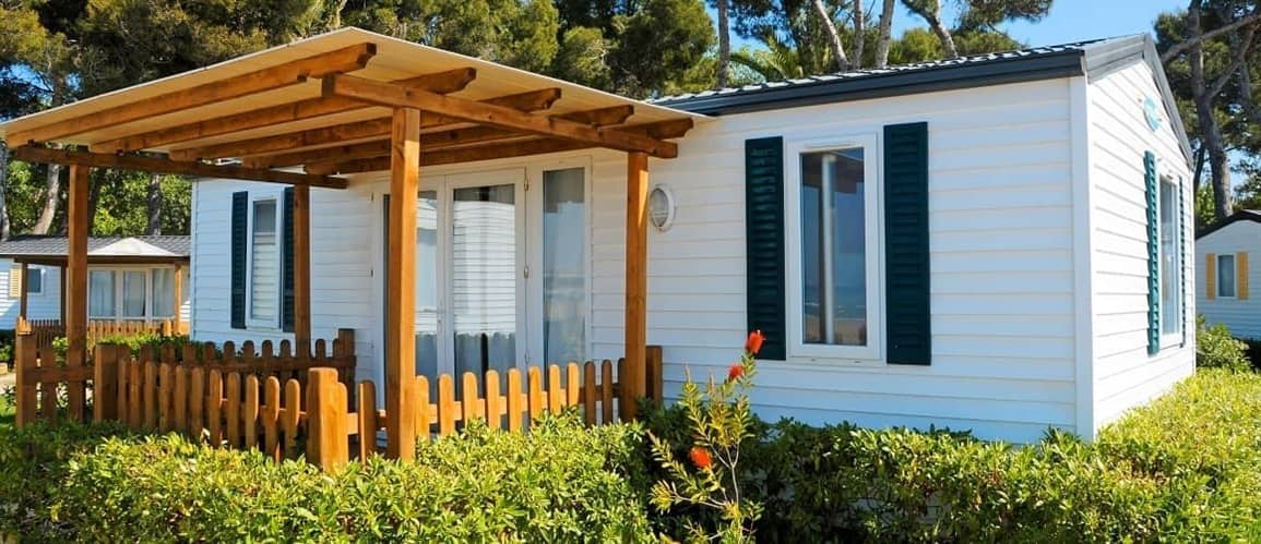 Modular home nestled in bushes.