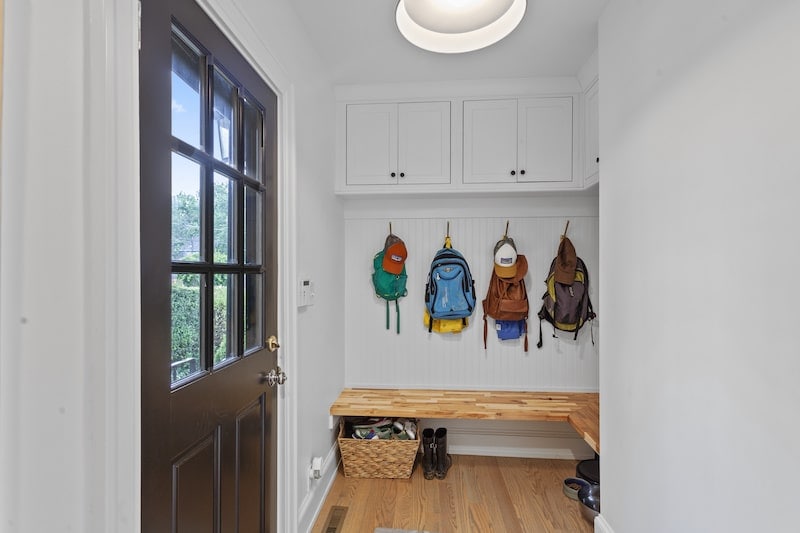 Mudroom addition with backpack hooks with benches and under bench storage.