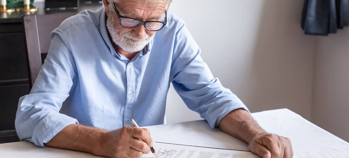 Older gentleman singing documents.