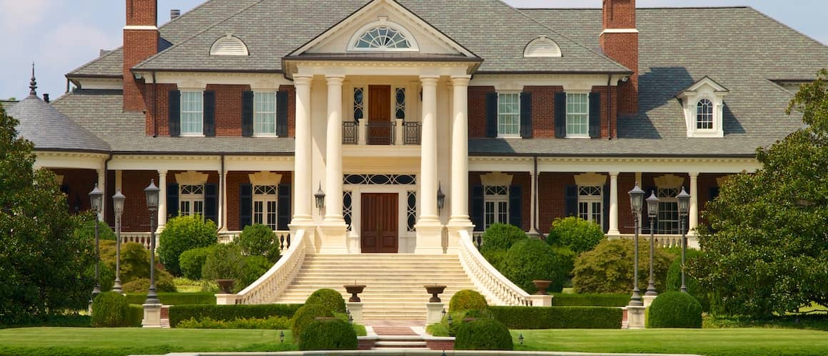 Exterior of a big, luxurious mansion.