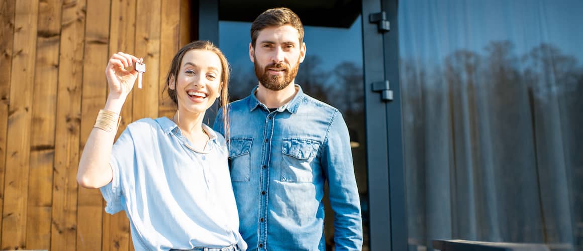 Couple in front of new home they negotiated ROFR for.