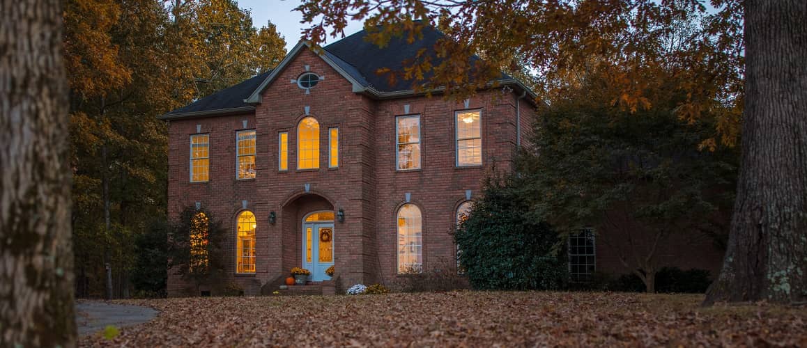 Red brick colonial home in fall