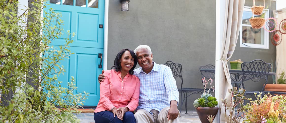 Older couple on porch of family home.