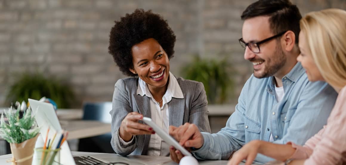 couple talking to agent on carrying costs