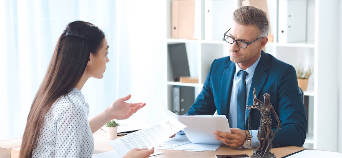 Woman speaking to an attorney.