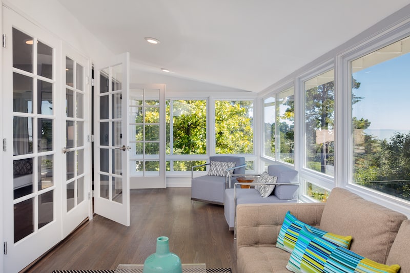 Sunroom addition with large windows. 