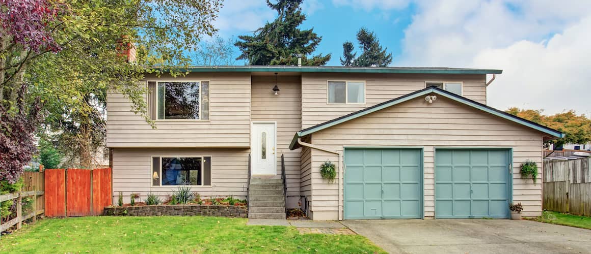 Traditional northwest house with teal garage.
