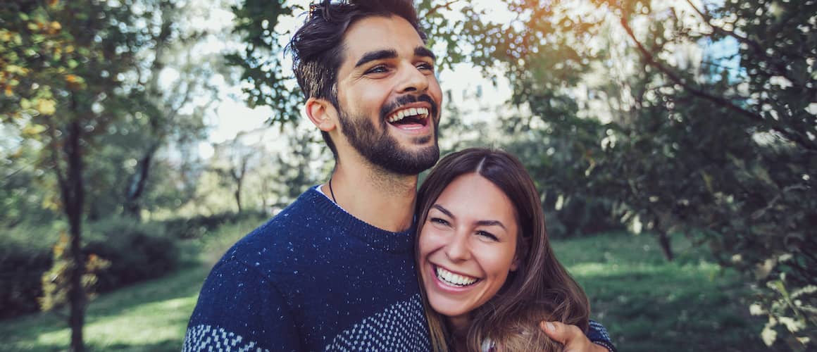 Happy Young Couple On New Land Purchased With USDA Loan