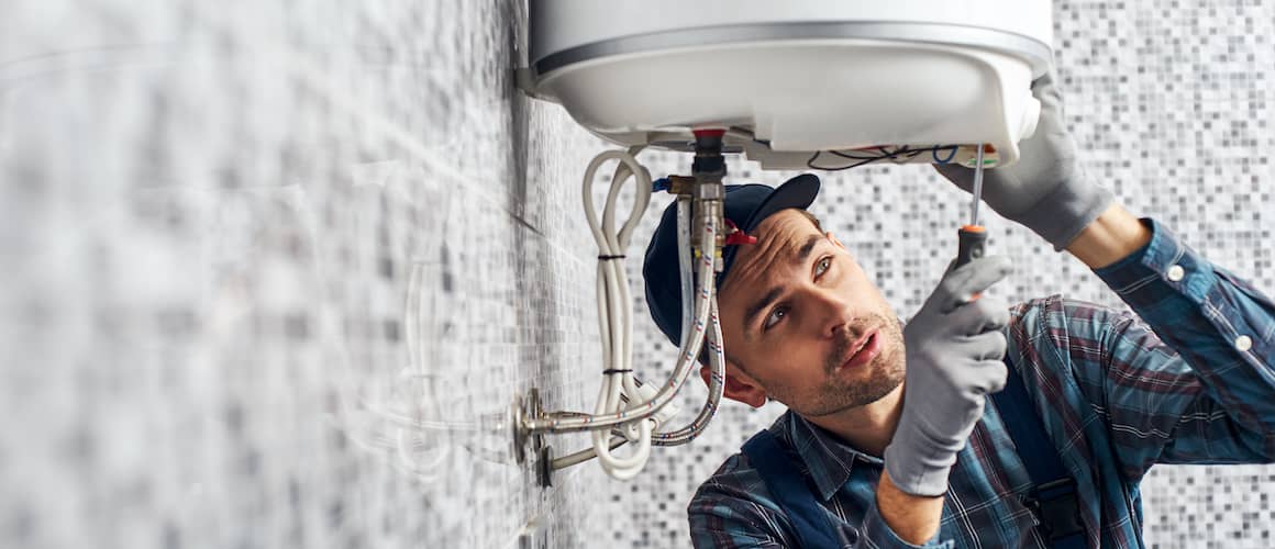 man fixing water heater