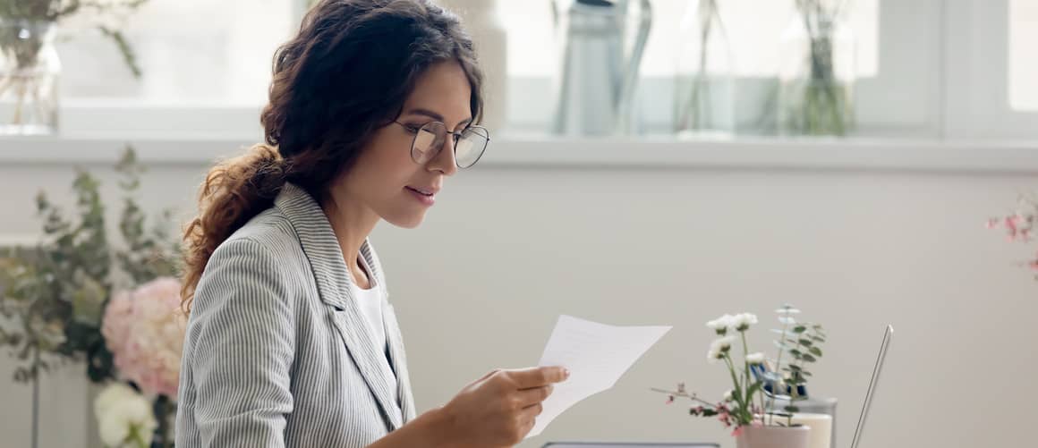 Woman looking at mail at home.