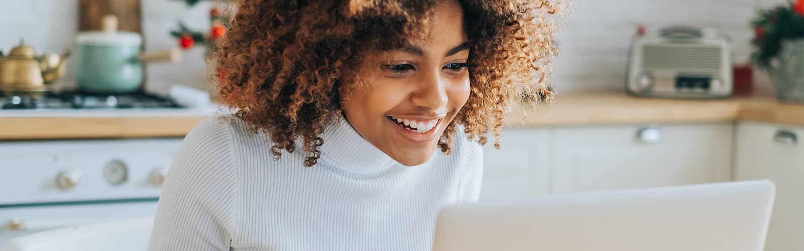 Woman On Laptop Researching Mortgage Rates
