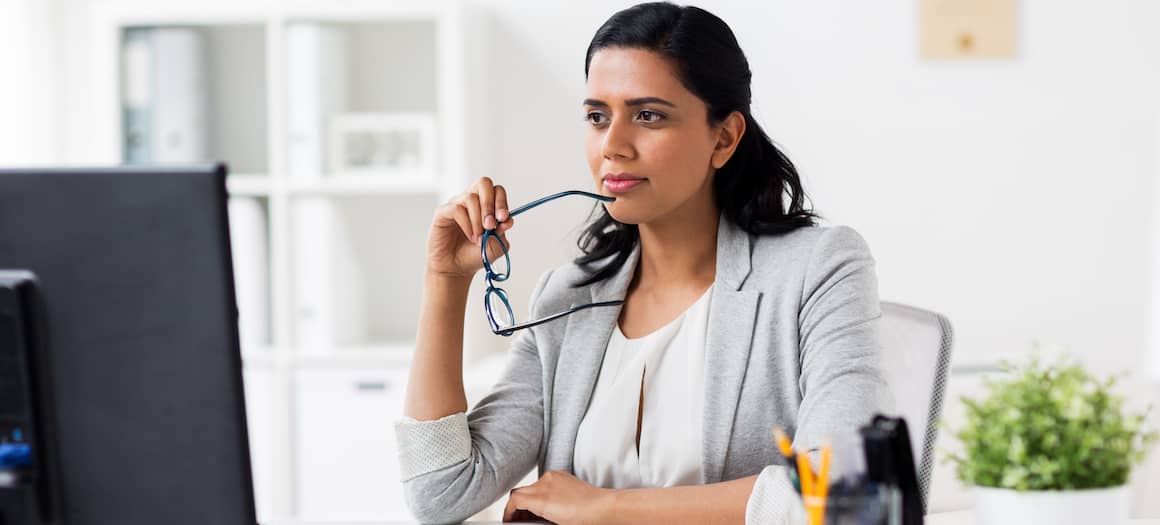 woman on computer thinking