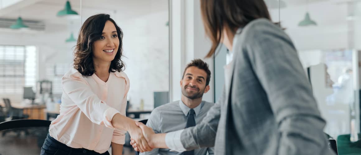Woman shaking hands with businesswoman.