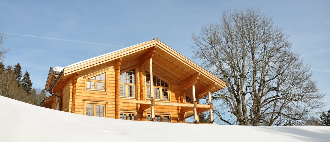 wood house surrounded by snow